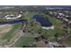 Aerial view of a golf course with multiple fairways, water hazards, and residential areas surrounding the course at 109 Southampton N Pl # 245, Venice, FL 34293