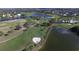 Expansive aerial view of a lush golf course community with multiple water features and well-maintained greens at 109 Southampton N Pl # 245, Venice, FL 34293