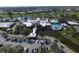Stunning aerial view of the community clubhouse with pool, parking, and lush landscaping at 109 Southampton N Pl # 245, Venice, FL 34293