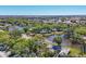 Beautiful aerial view of homes nestled among mature trees and a tranquil lake, creating a serene environment at 109 Southampton N Pl # 245, Venice, FL 34293