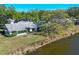 Aerial view of the property featuring a waterfront view and well-manicured grounds at 109 Southampton N Pl # 245, Venice, FL 34293
