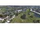 Expansive aerial view showcases a golf course, community center, and lush landscaping at 109 Southampton N Pl # 245, Venice, FL 34293