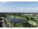 Expansive aerial shot of golf course, lakes, and a road, showcasing the community's vast recreational amenities at 109 Southampton N Pl # 245, Venice, FL 34293