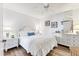 Bright bedroom featuring a ceiling fan, stylish white furniture, and hardwood floors at 109 Southampton N Pl # 245, Venice, FL 34293