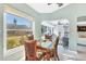 Breakfast nook with beautiful view of the yard and a glass-topped table with seating for four at 109 Southampton N Pl # 245, Venice, FL 34293
