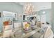 Open dining area with chandelier, large windows, and seamless flow to the kitchen and living spaces at 109 Southampton N Pl # 245, Venice, FL 34293