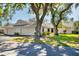 Charming single-story home featuring a neutral color, two-car garage, and mature trees at 109 Southampton N Pl # 245, Venice, FL 34293