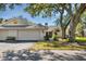 Charming villa featuring a two-car garage, lush landscaping, and a welcoming facade in a tranquil setting at 109 Southampton N Pl # 245, Venice, FL 34293