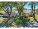 Well-maintained villa with a tile roof, lush landscaping, and mature trees offering shade and curb appeal at 109 Southampton N Pl # 245, Venice, FL 34293