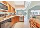 Functional kitchen featuring wooden cabinets, updated appliances, and a cozy breakfast nook with natural light at 109 Southampton N Pl # 245, Venice, FL 34293