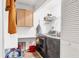 Functional laundry room with modern washer and dryer, storage cabinets, and ample counter space at 109 Southampton N Pl # 245, Venice, FL 34293
