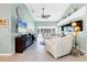 Spacious living room with high ceilings, tile floors, and sliding glass doors, perfect for indoor-outdoor living at 109 Southampton N Pl # 245, Venice, FL 34293