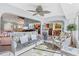 Open-concept sunroom with wicker furniture and views into the kitchen and dining area at 109 Southampton N Pl # 245, Venice, FL 34293