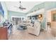 Comfortable living room with tile floors, vaulted ceiling, and open access to sunroom at 109 Southampton N Pl # 245, Venice, FL 34293