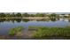 Picturesque view of a calm pond reflecting the golf course, showcasing the natural beauty of the community at 109 Southampton N Pl # 245, Venice, FL 34293