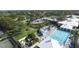 Community pool and patio with lounge chairs, umbrellas, and lush landscaping for relaxation at 109 Southampton N Pl # 245, Venice, FL 34293