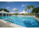 Resort-style swimming pool with clear blue water and surrounding lounge area, perfect for relaxation and recreation at 109 Southampton N Pl # 245, Venice, FL 34293