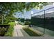 Well-maintained tennis courts lined by green foliage, offering a private and scenic setting for sports enthusiasts at 109 Southampton N Pl # 245, Venice, FL 34293