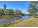 Scenic waterfront view showcasing the tranquil lake and lush greenery surrounding the property at 109 Southampton N Pl # 245, Venice, FL 34293