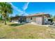 Home featuring a screened-in lanai and a spacious backyard, ideal for outdoor enjoyment at 1110 Gladstone Blvd, Englewood, FL 34223