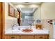 Neutral bathroom with a single sink, tile backsplash, and a large mirror at 1110 Gladstone Blvd, Englewood, FL 34223