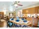 Open concept eat-in kitchen next to the living room, hardwood flooring, and decorative table setting at 1110 Gladstone Blvd, Englewood, FL 34223