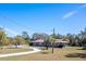 A single story home on large lot with mature landscaping and circular driveway at 1110 Gladstone Blvd, Englewood, FL 34223