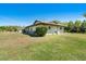 Single-story home on an oversized lot with a detached garage and lush landscaping at 1110 Gladstone Blvd, Englewood, FL 34223