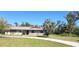 Charming single-story home featuring a well-manicured lawn and decorative rustic accents on the front facade at 1110 Gladstone Blvd, Englewood, FL 34223