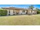 Charming single-story home featuring a well-manicured lawn, stone accents, and mature landscaping at 1110 Gladstone Blvd, Englewood, FL 34223