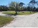 Gravel driveway with a circle feature and a flagpole in the front yard at 1110 Gladstone Blvd, Englewood, FL 34223