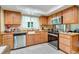 Well-lit kitchen with stainless steel appliances, granite countertops, and wood cabinetry at 1110 Gladstone Blvd, Englewood, FL 34223