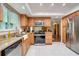 Modern kitchen with stainless steel appliances, granite countertops, and wood cabinetry at 1110 Gladstone Blvd, Englewood, FL 34223