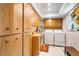 Well-lit laundry room with ample storage cabinets, washer, and dryer for efficient laundry management at 1110 Gladstone Blvd, Englewood, FL 34223