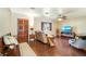Cozy living room with hardwood floors, decorative carved door and comfortable seating at 1110 Gladstone Blvd, Englewood, FL 34223