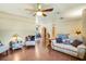 Spacious living room featuring hardwood flooring, ceiling fan and comfortable furnishings at 1110 Gladstone Blvd, Englewood, FL 34223