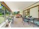 Enclosed patio featuring a jacuzzi, multiple seating options and ample natural light at 1110 Gladstone Blvd, Englewood, FL 34223