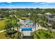 Aerial view of the community splash pad surrounded by tropical landscaping and shaded seating area at 11532 Okaloosa Dr, Venice, FL 34293