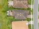 Aerial view of neighborhood homes with tile roofs, well-manicured lawns, and brick patios at 11655 Renaissance Blvd, Venice, FL 34293