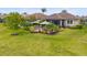 Aerial view of a lush backyard with patio seating areas and colorful landscaping at 11655 Renaissance Blvd, Venice, FL 34293