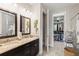 Granite counters adorn the dual sink vanity in this well-lit bathroom at 11655 Renaissance Blvd, Venice, FL 34293