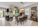 Dining room area with wood table, decorative lighting, and sliding glass doors to the lanai at 11655 Renaissance Blvd, Venice, FL 34293