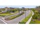 Community entrance with manicured landscaping, palm trees, and signage at 11655 Renaissance Blvd, Venice, FL 34293