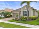 Beautiful single-story home with lush landscaping, a well-manicured lawn, and a welcoming entrance at 11655 Renaissance Blvd, Venice, FL 34293