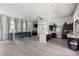 Bright community kitchen with stainless appliances, island, counter seating, and wood-look flooring at 11655 Renaissance Blvd, Venice, FL 34293