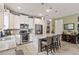 Bright kitchen featuring stainless steel appliances, granite countertops, and a large island with seating at 11655 Renaissance Blvd, Venice, FL 34293