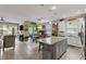 Bright kitchen features a center island with granite countertops and stainless steel appliances at 11655 Renaissance Blvd, Venice, FL 34293