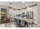 Bright kitchen featuring stainless steel appliances, granite countertops, and a large island with seating at 11655 Renaissance Blvd, Venice, FL 34293