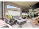 Comfortable lanai features cozy seating, a ceiling fan, and outdoor entertaining space at 11655 Renaissance Blvd, Venice, FL 34293