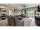 Comfortable living room with a ceiling fan, tile floors, and sliding glass doors to the outside at 11655 Renaissance Blvd, Venice, FL 34293